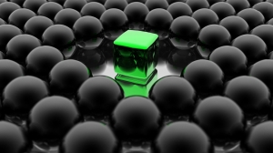 Cubo verde sobre esferas negras